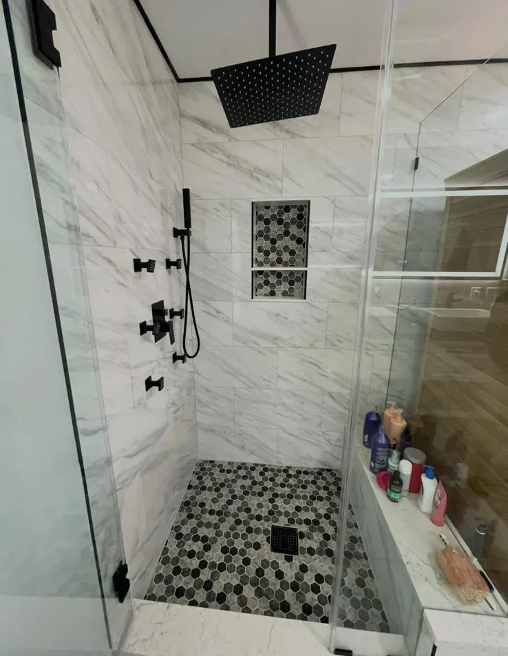 Walk-in shower with marble-look tile and matte black fixtures